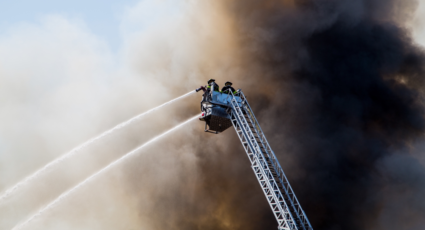 Brandweermensen in de rook